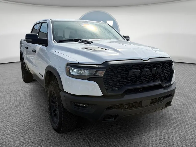 2026 RAM 1500 Rebel Crew Cab 4x4 5'7' Box in Bright White Clearcoat — front three-quarter view