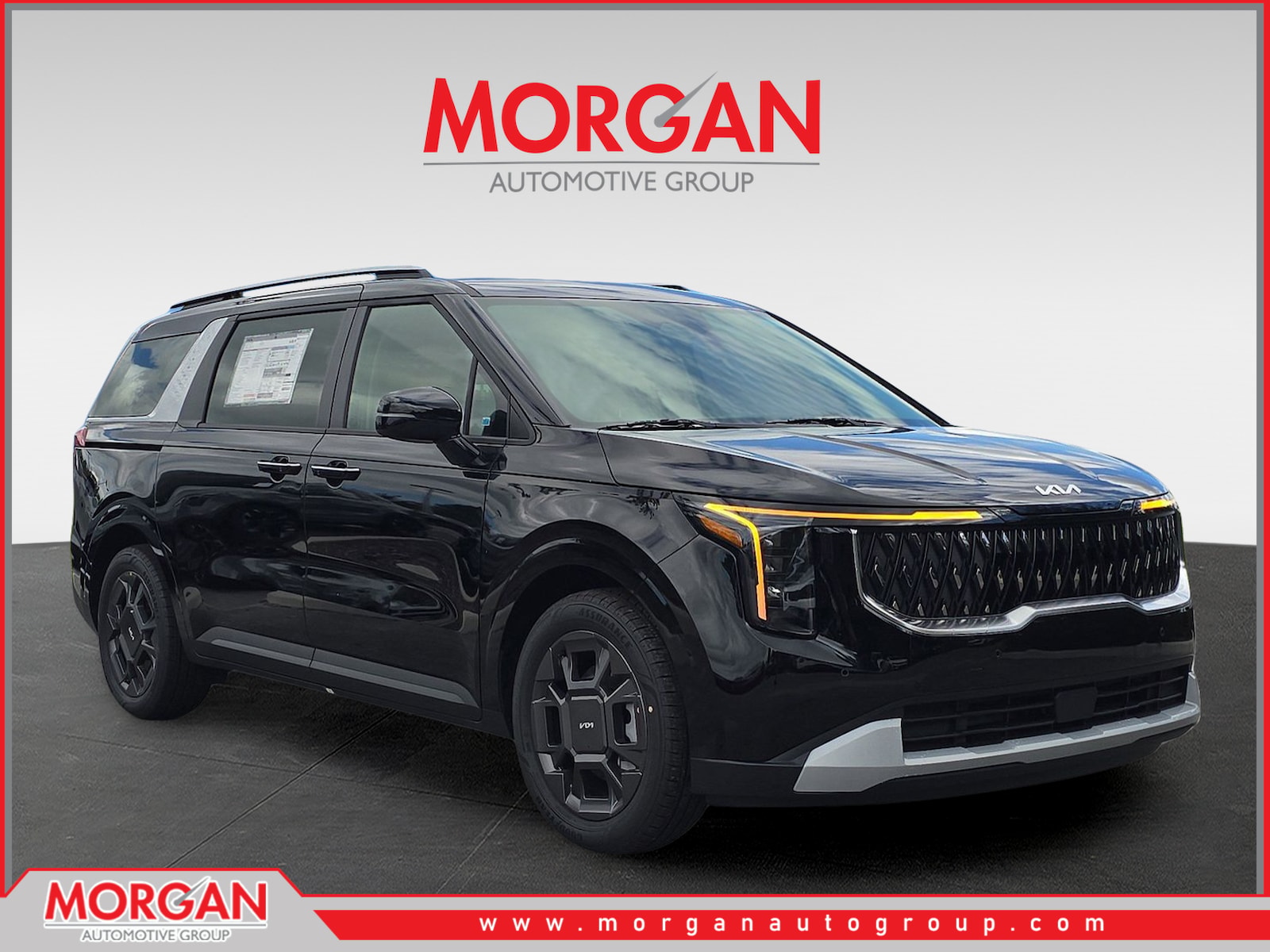 2026 Kia Carnival Hybrid EX in Aurora Black Pearl — front three-quarter view