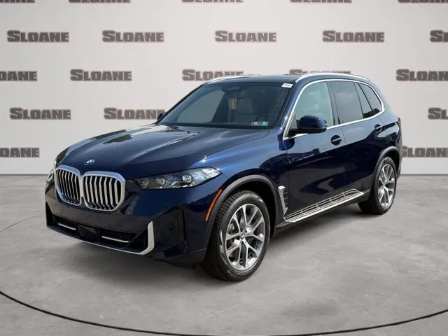 2026 BMW X5 xDrive50e in Tanzanite Blue II Metallic — front three-quarter view