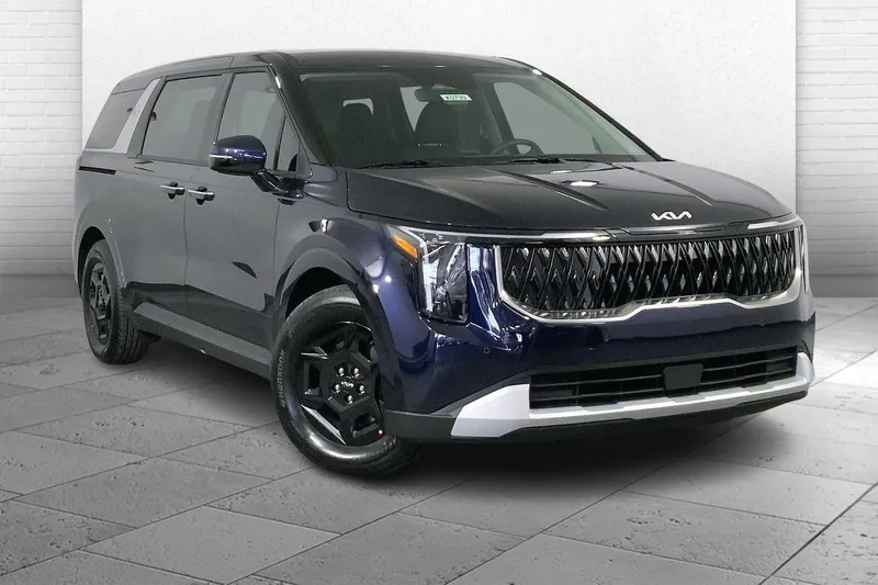 2026 Kia Carnival LXS in Deep Chroma Blue — front three-quarter view