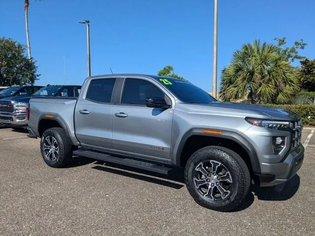 2025 GMC Canyon AT4 in Sterling Metallic — front three-quarter view