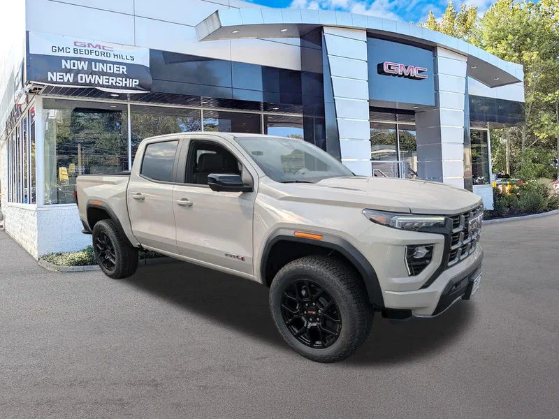 2026 GMC Canyon 4WD AT4 in Coastal Dune — front three-quarter view