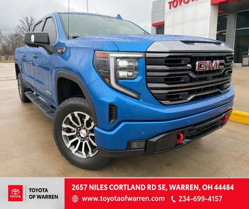 2023 GMC Sierra AT4 in Blue Metallic — front three-quarter view