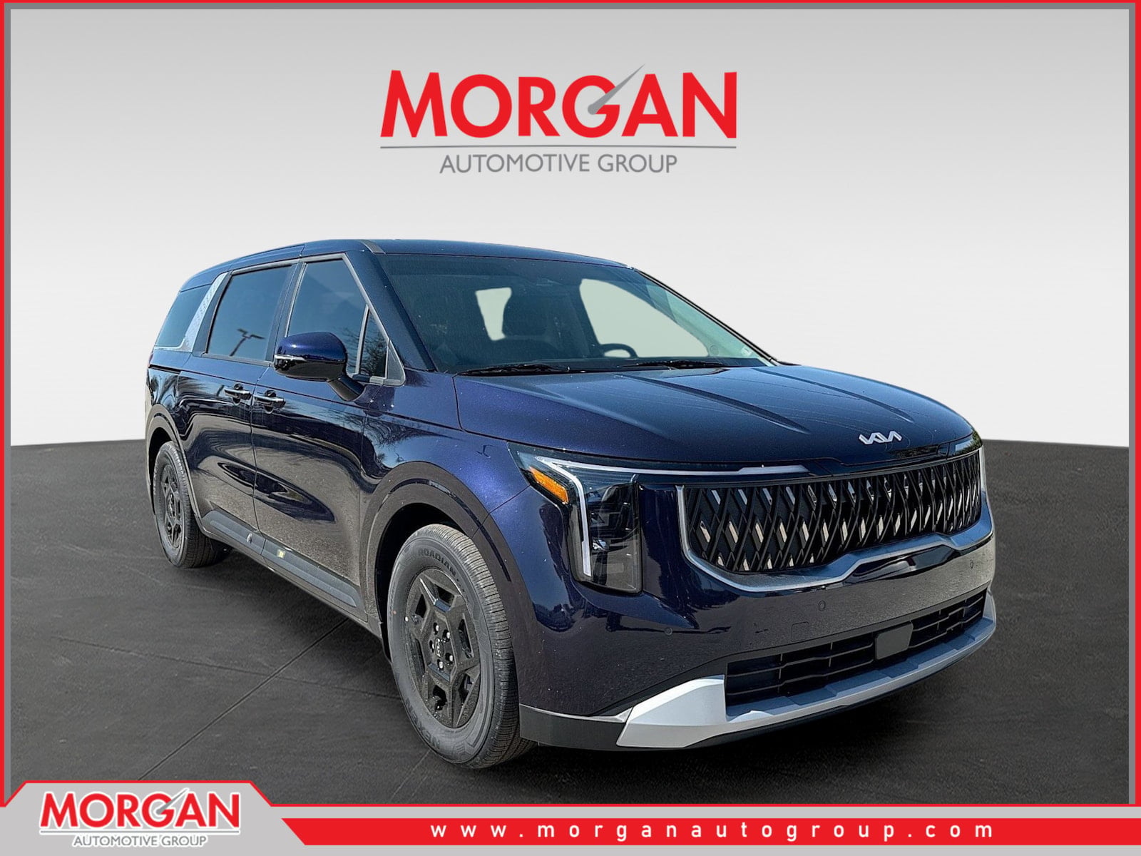 2026 Kia Carnival LXS in Deep Chroma Blue — front three-quarter view